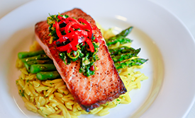 Catered salmon and asparagus over pasta