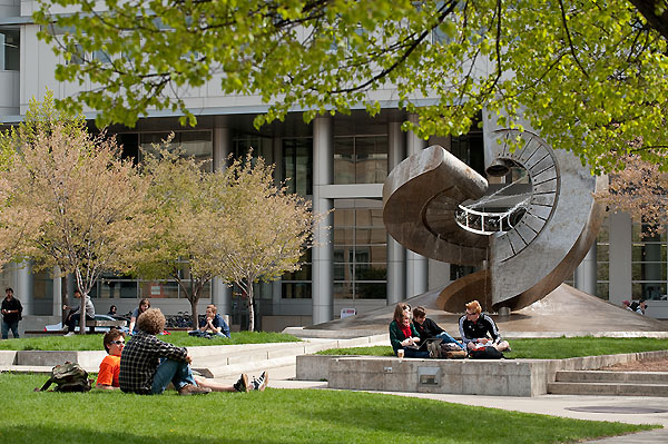 Students lounge on the grass near the UW Engineering Building
