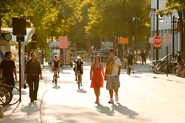 People stroll down State Street in Madison, WI