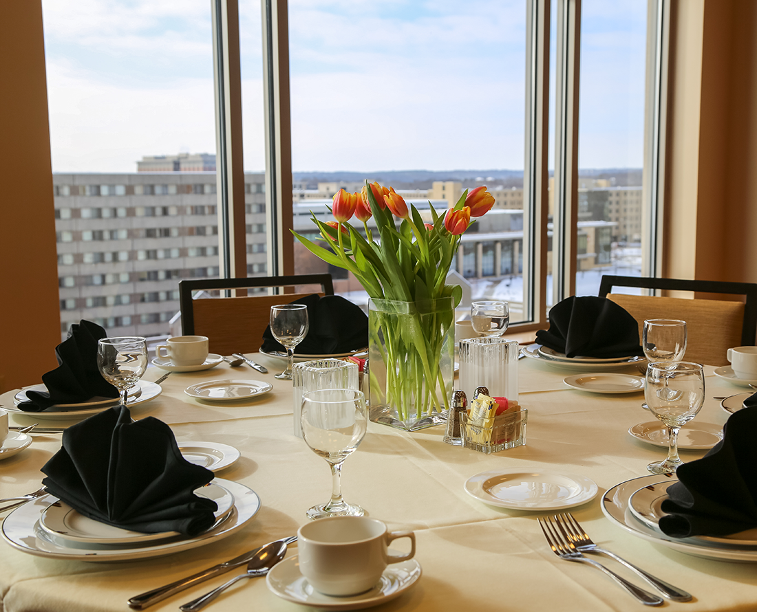 Arranged table with bouquet and a city view window