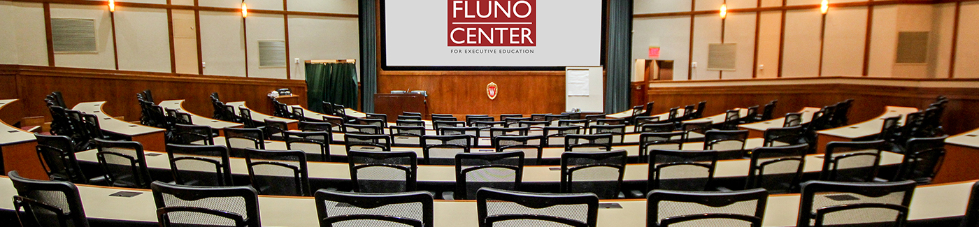 Auditorium with rows of seats and tables